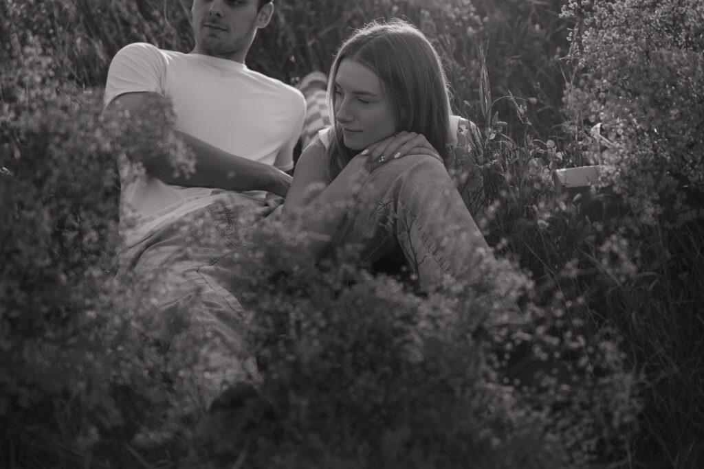 couples posing in a field in canada
