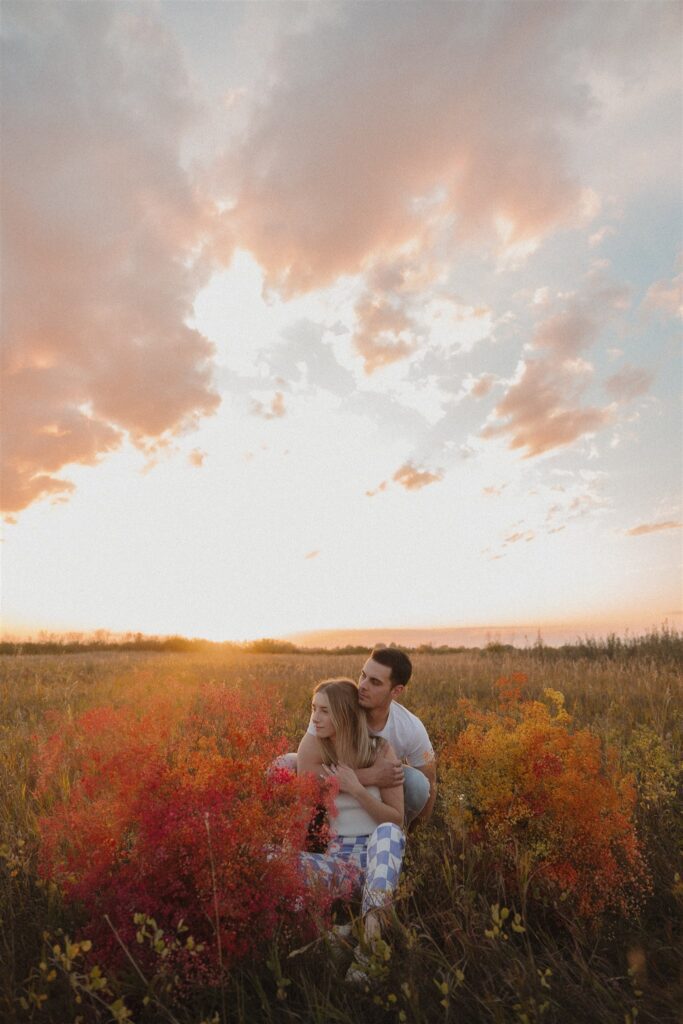 couples posing in a field in canada
