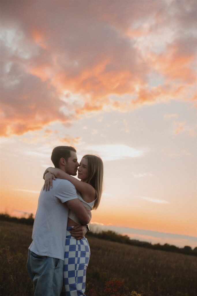 couples posing in a field in canada
