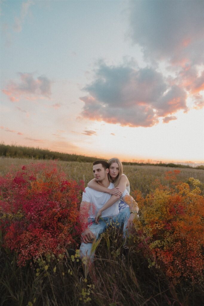 couples posing in a field in canada
