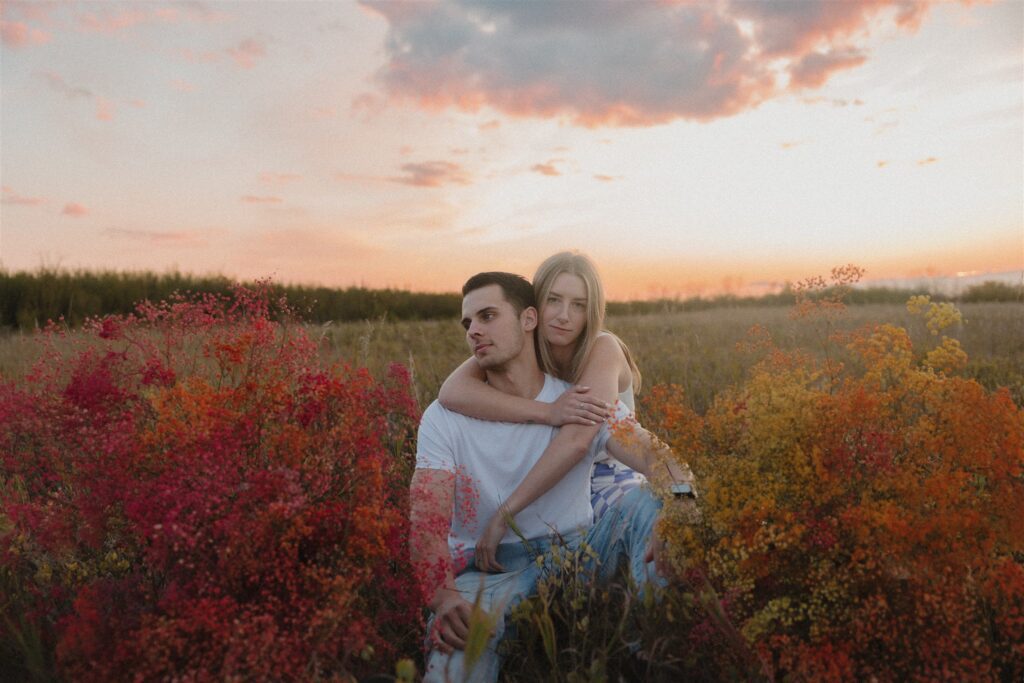 couples posing in a field in canada
