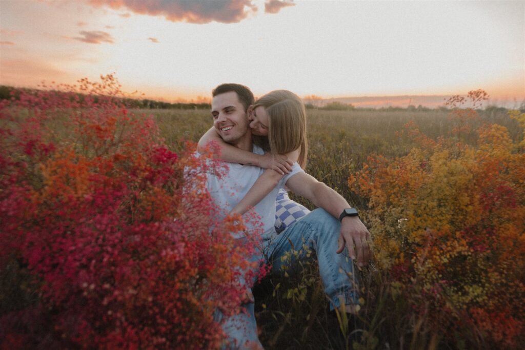 couples posing in a field in canada
