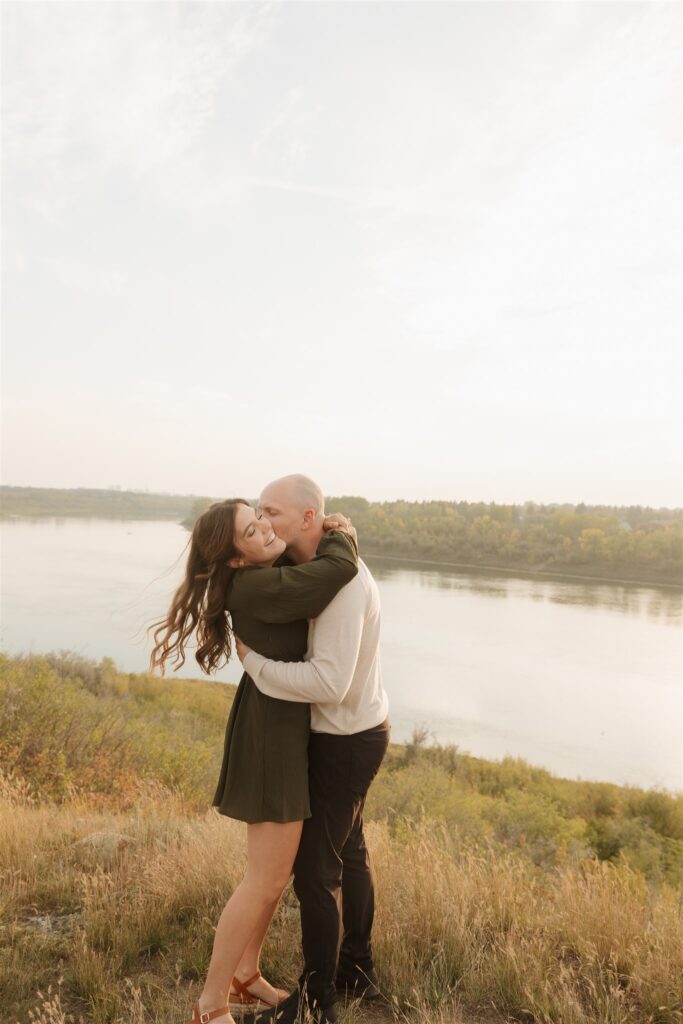 couple posing outdoors in saskatoon for a golden hour engagement session
