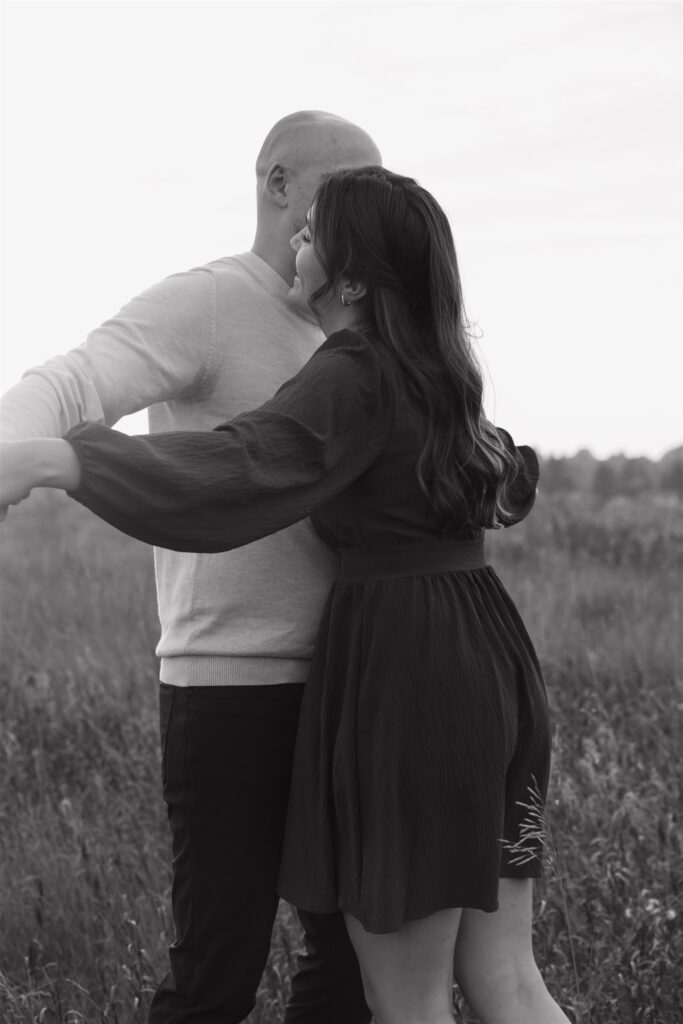 couple posing outdoors in saskatoon for a golden hour engagement session