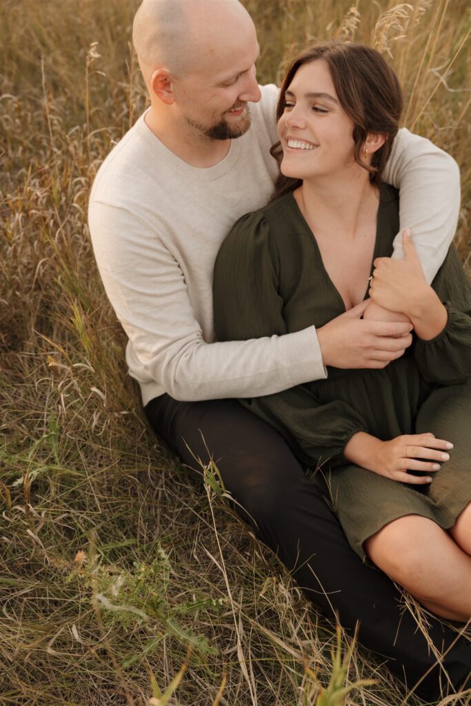 couple posing outdoors in saskatoon for a golden hour engagement session
