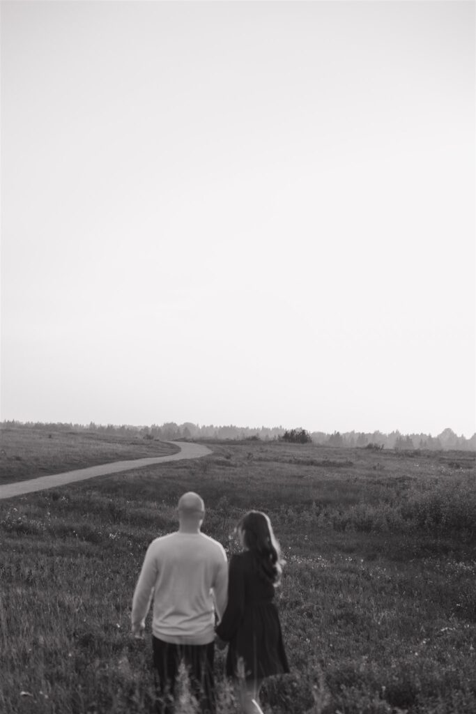 couple posing outdoors in saskatoon for a golden hour engagement session
