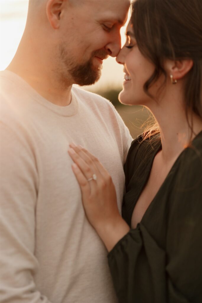 couple posing outdoors in saskatoon for a golden hour engagement session
