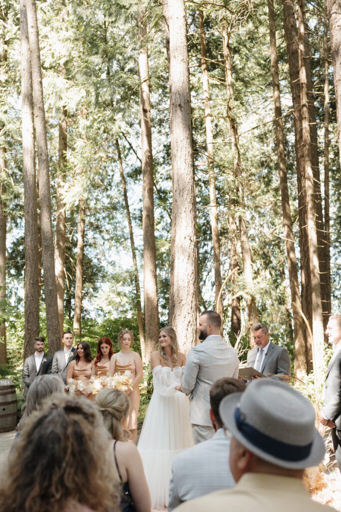 Bride and groom exchanging vows during their romantic forrest wedding ceremony.