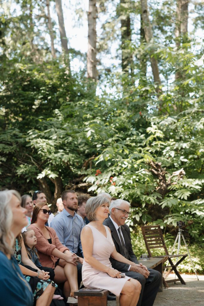 Bride and groom exchanging vows during their romantic forrest wedding ceremony.