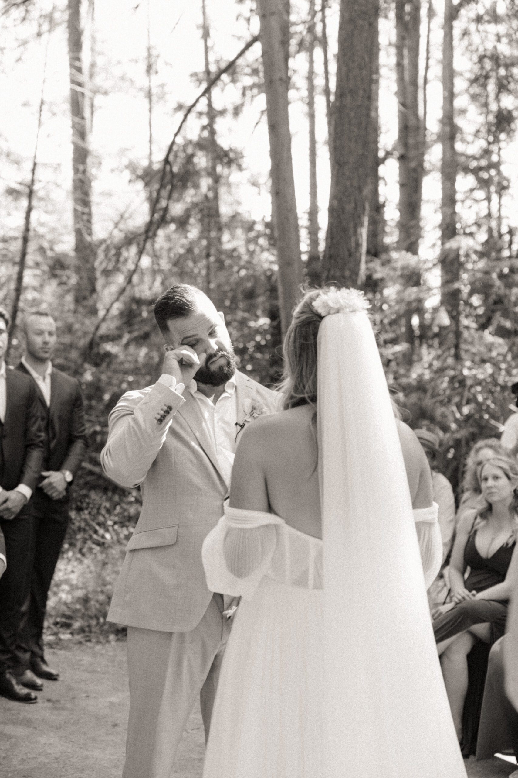 Bride and groom exchanging vows in forrest