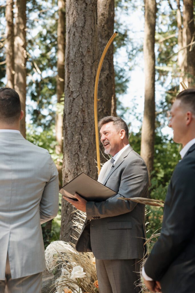 Bride and groom exchanging vows during their romantic forrest wedding ceremony.