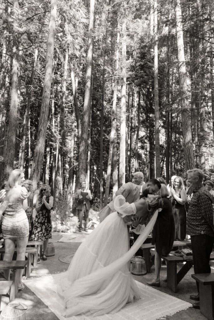 Bride and groom exchanging vows during their romantic forrest wedding ceremony.