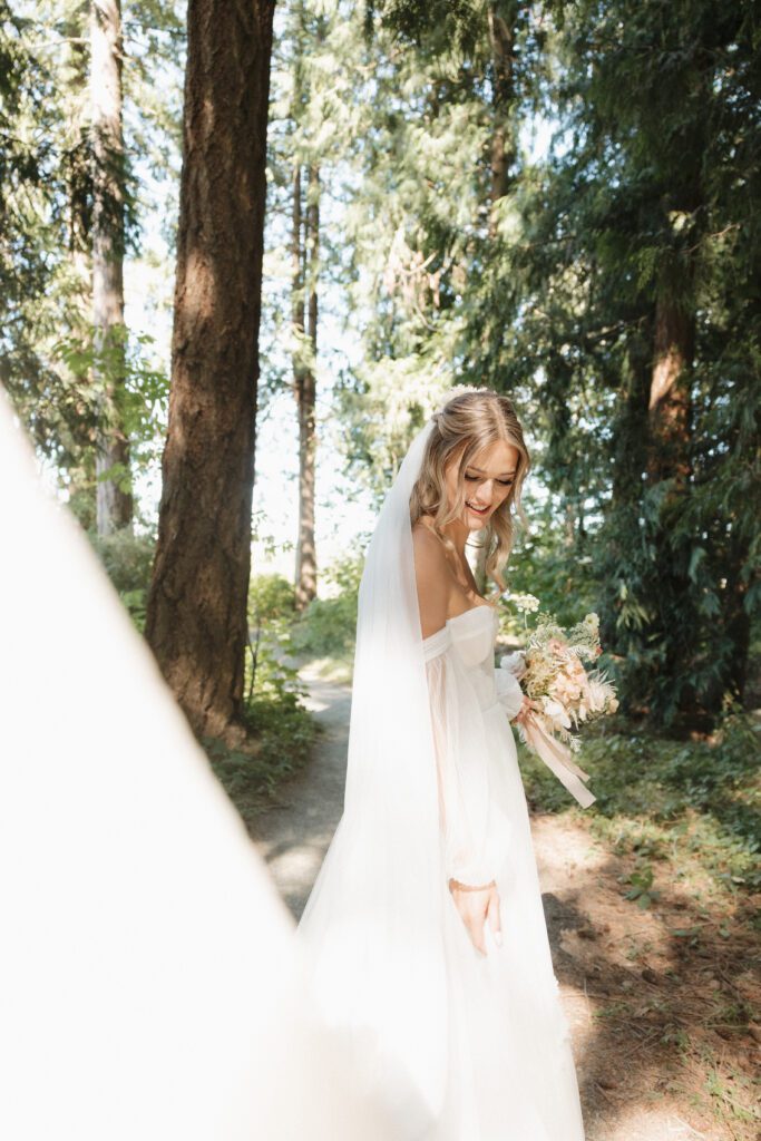 Bride and groom posing in a romantic forrest to capture elegant wedding photos.