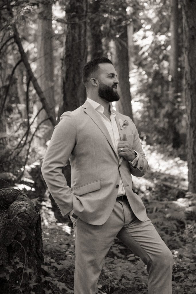 Bride and groom posing in a romantic forrest to capture elegant wedding photos.