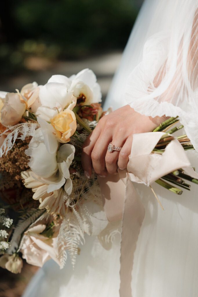 Bride and groom posing in a romantic forrest to capture elegant wedding photos.