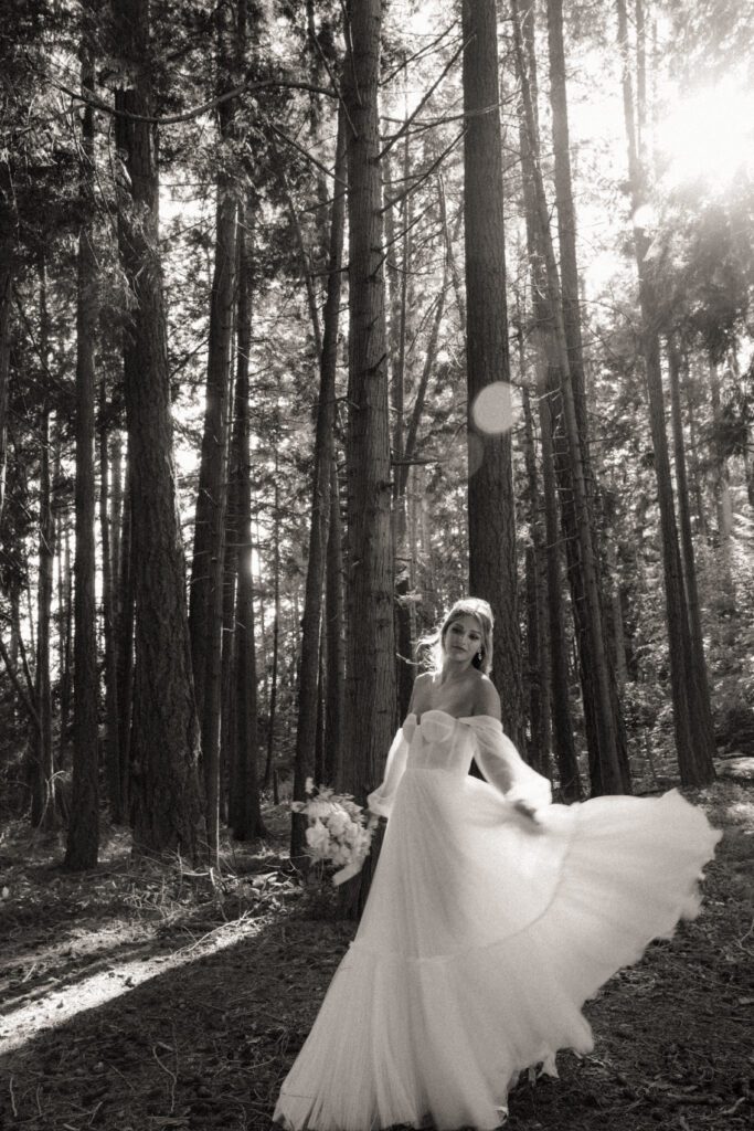 Bride and groom posing in a romantic forrest to capture elegant wedding photos.