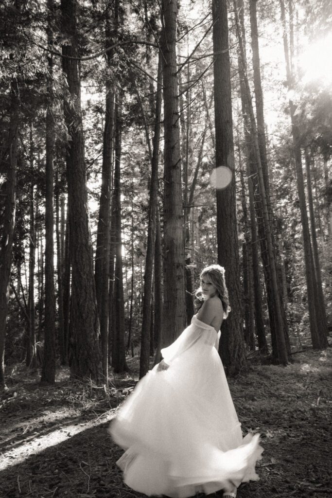 Bride and groom posing in a romantic forrest to capture elegant wedding photos.