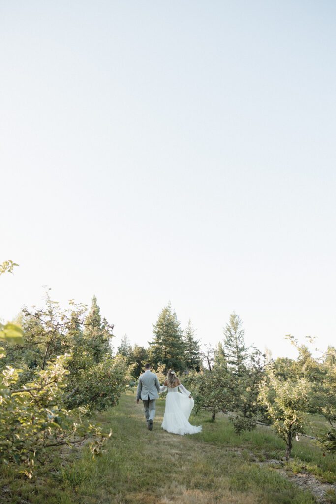 Bride and groom posing in a romantic forrest to capture elegant wedding photos.