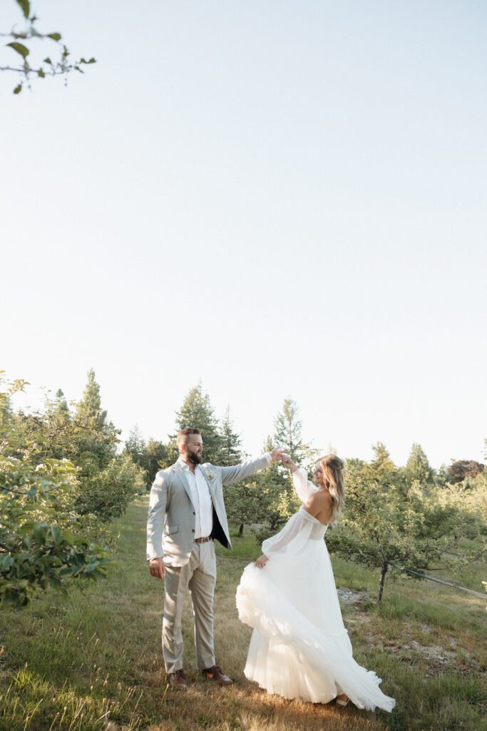 Bride and groom posing in a romantic forrest to capture elegant wedding photos.