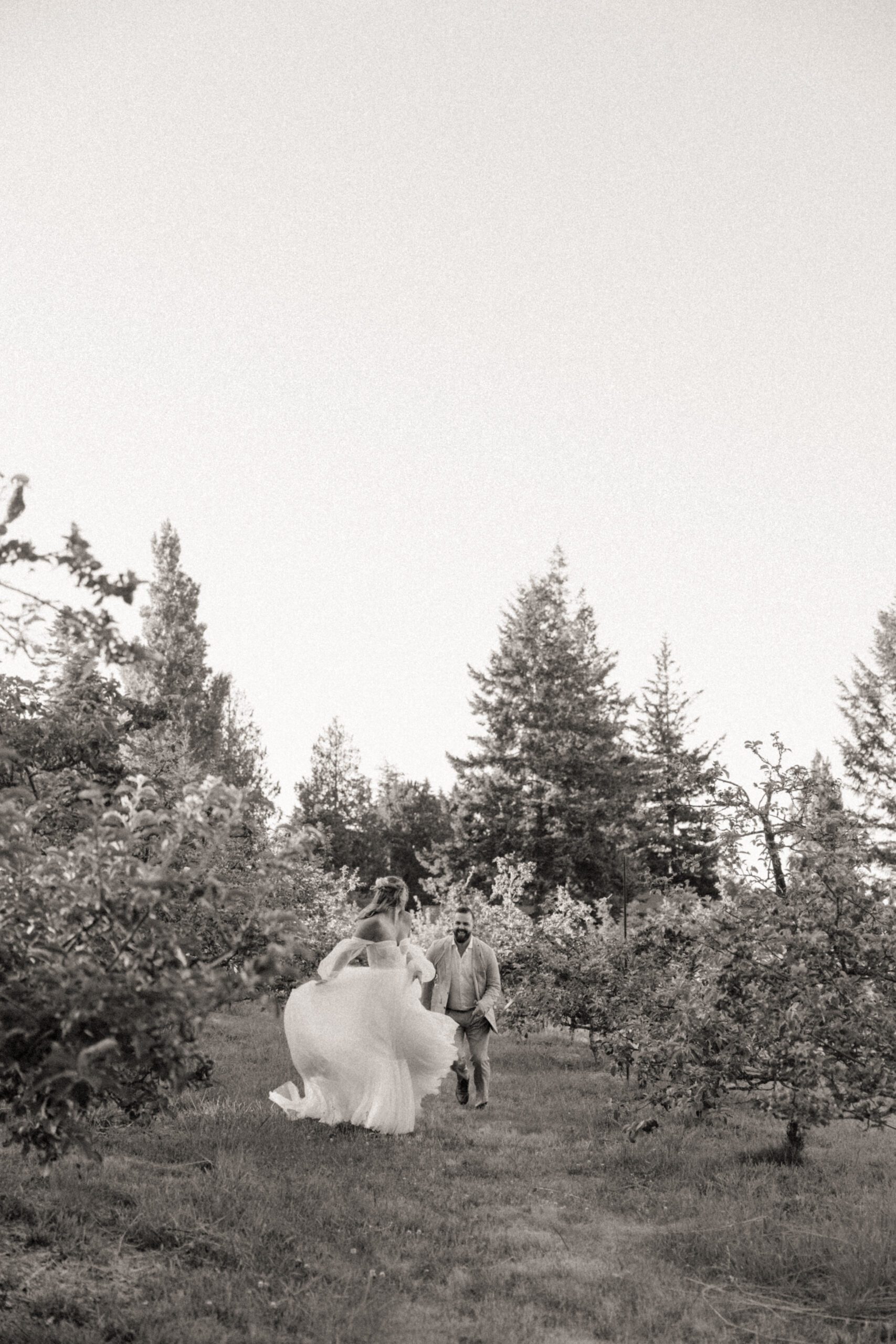 Bride and groom posing in a romantic forrest to capture elegant wedding photos.