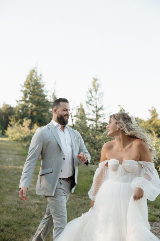 Bride and groom posing in a romantic forrest to capture elegant wedding photos.