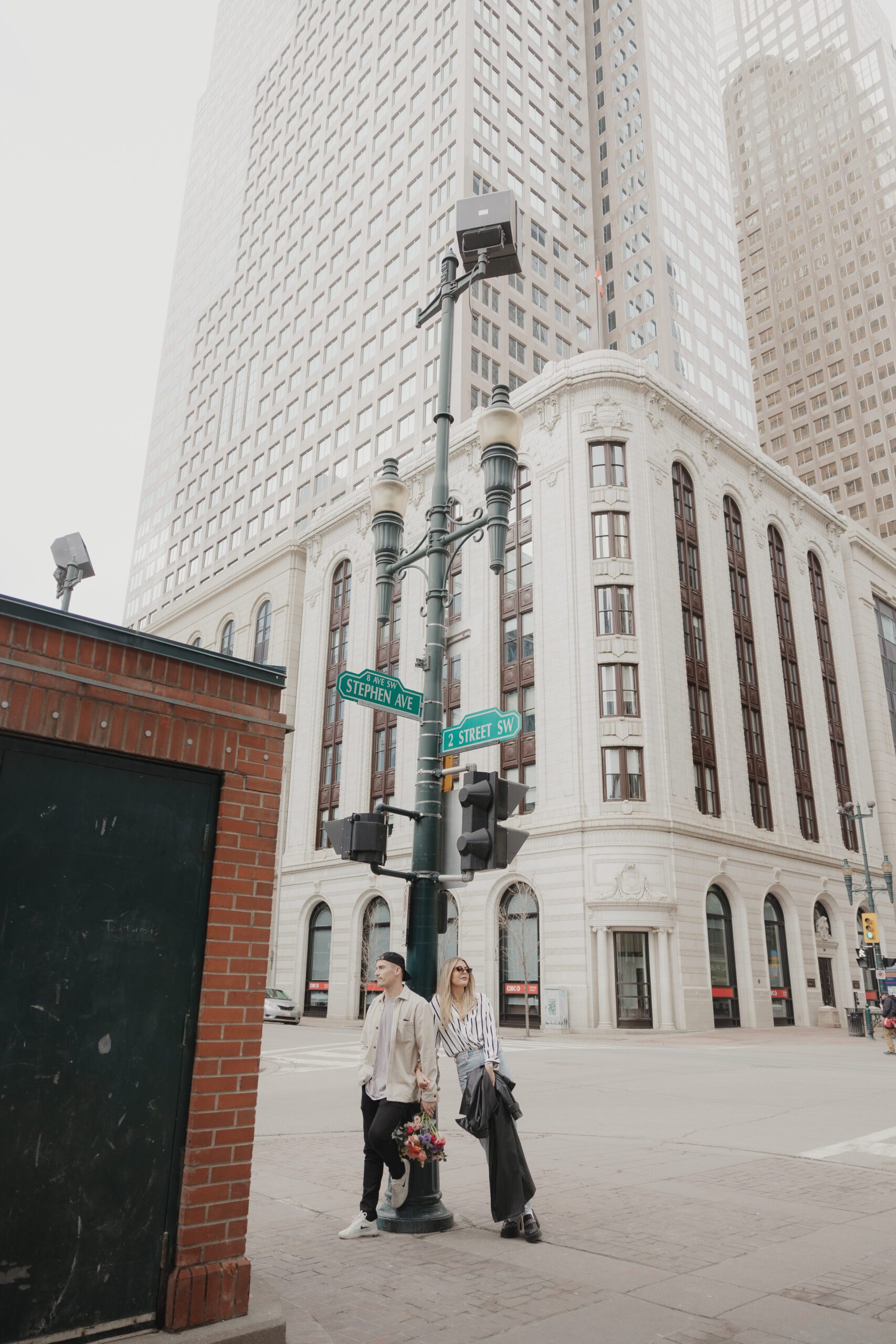 Couple exploring downtown Calgary during their modern edgy couples photoshoot 