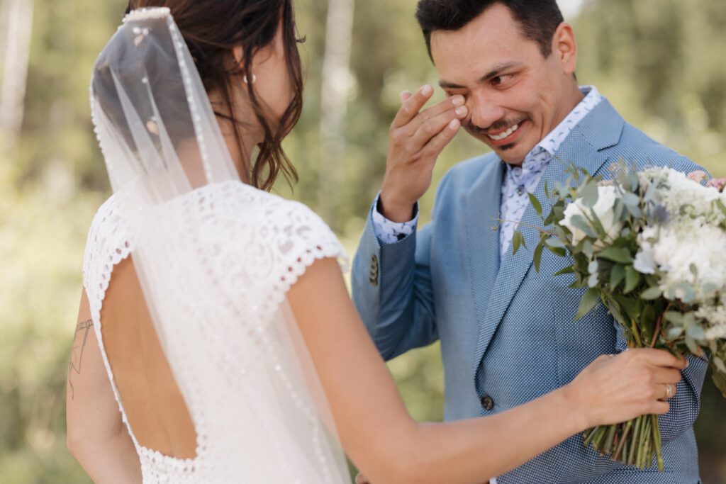 Bride and groom during their first look before their Candle Lake Wedding