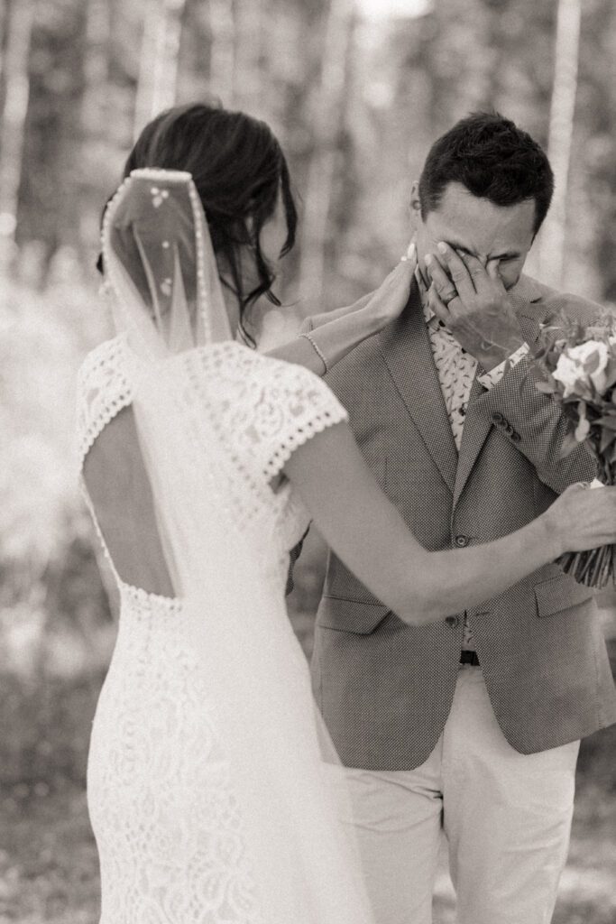 Bride and groom during their first look before their Candle Lake Wedding