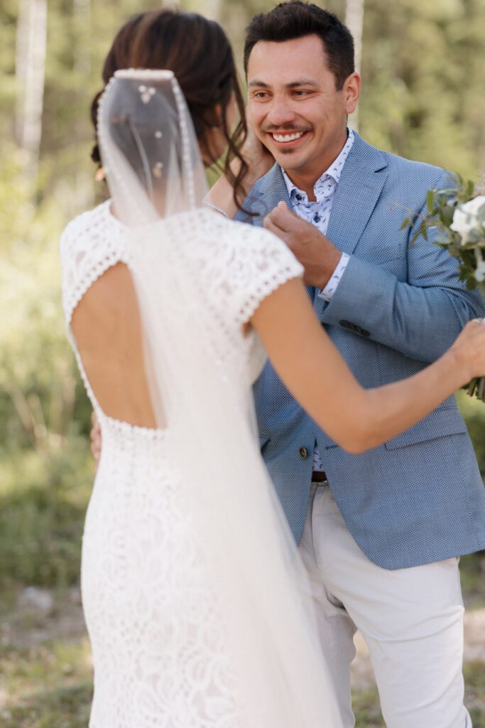 Bride and groom during their first look before their Candle Lake Wedding