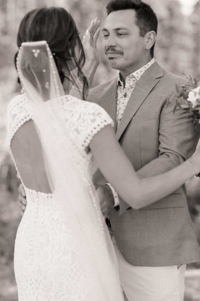 Bride and groom during their first look before their Candle Lake Wedding