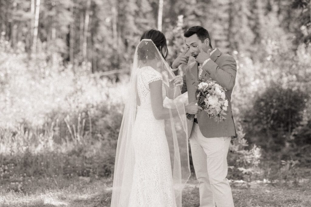 Bride and groom during their first look before their Candle Lake Wedding