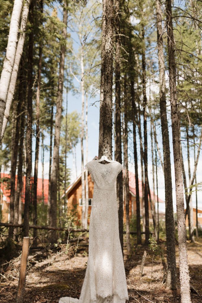 Wedding dress hanging up in the forrest