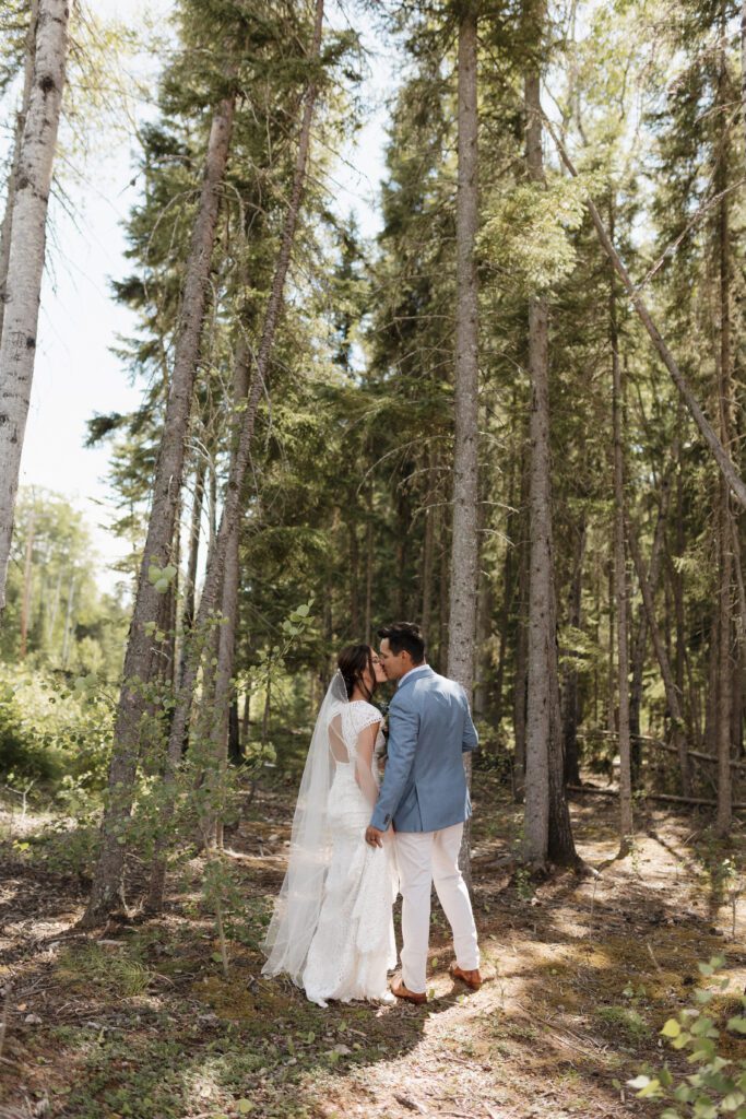 Bride and groom taking bridals in the forrest in Candle Lake Saskatchewan