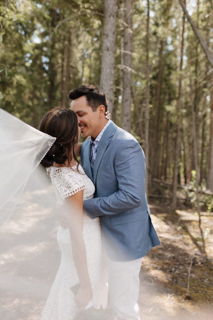 Bride and groom taking bridals in the forrest in Candle Lake Saskatchewan