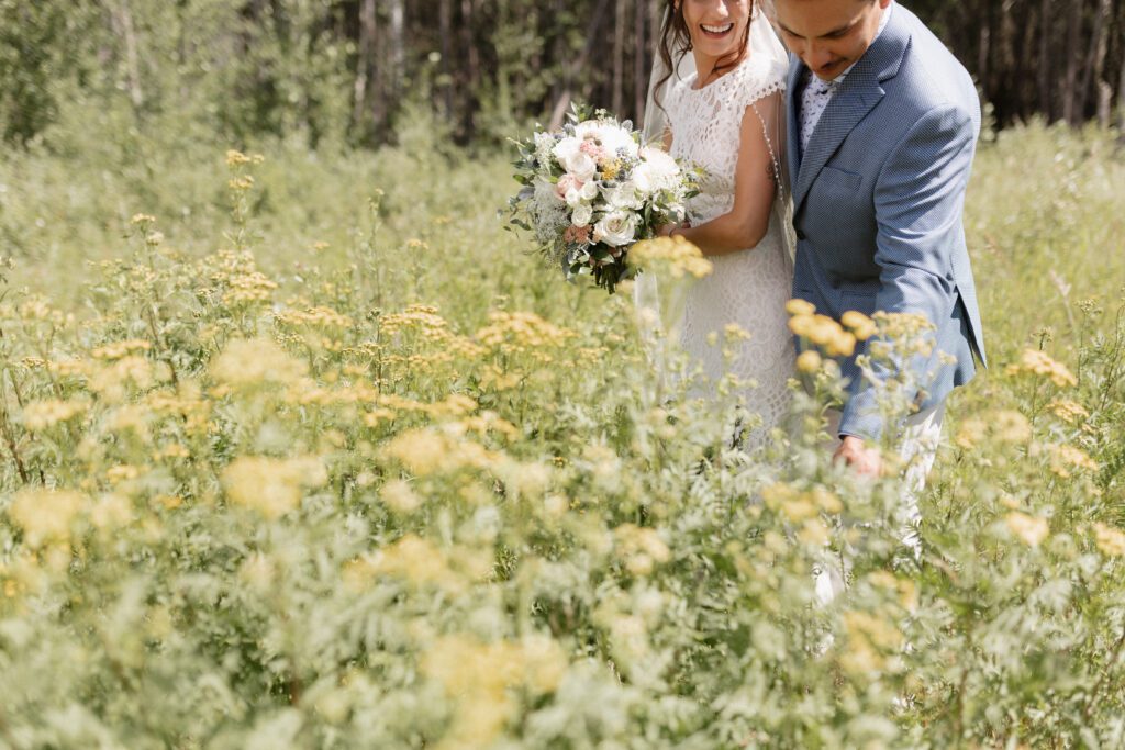 Bride and groom taking bridals in the forrest in Candle Lake Saskatchewan