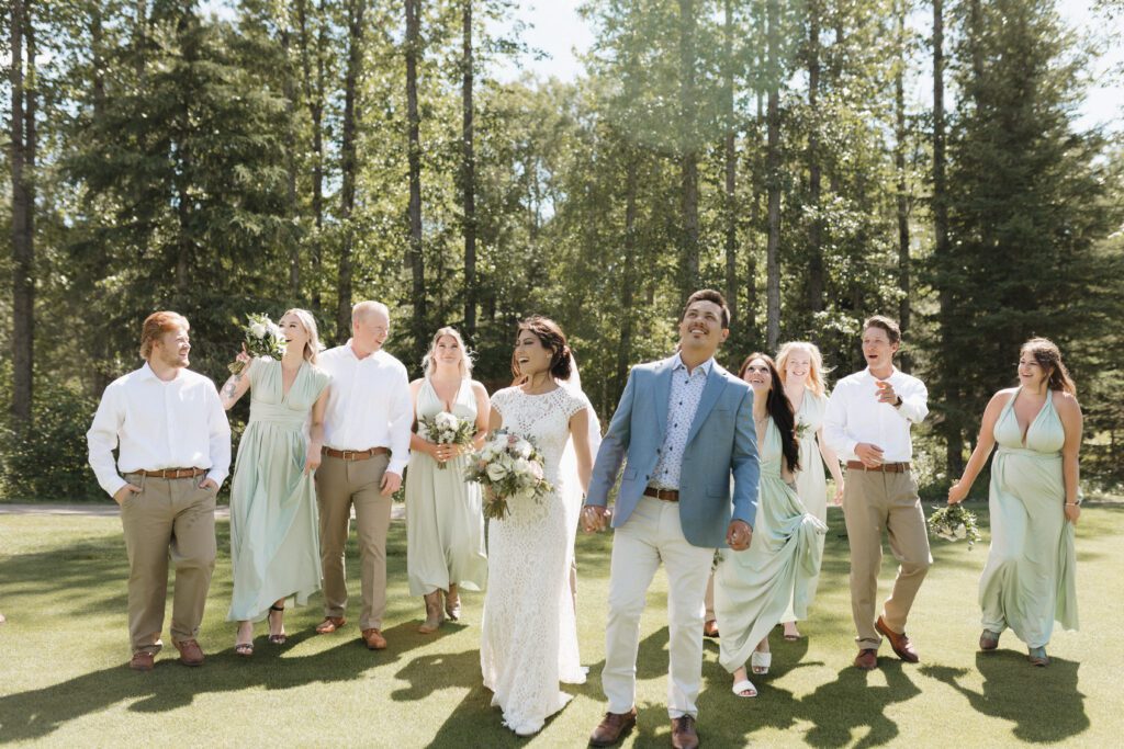 Bride and groom taking photos with their wedding party before their ceremony