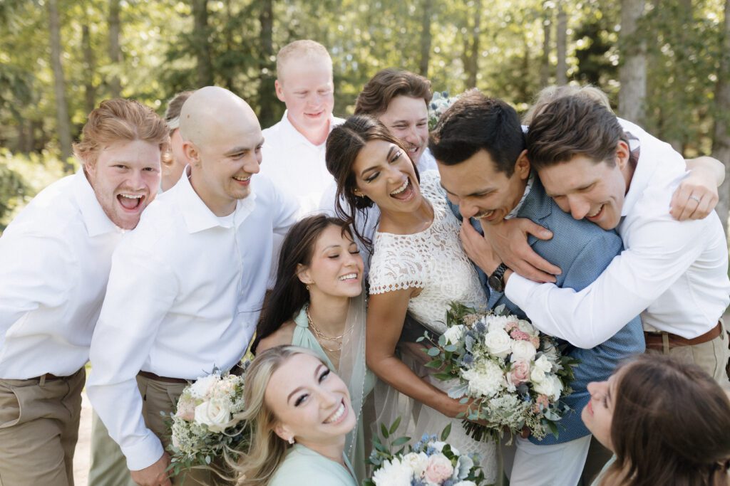 Bride and groom taking photos with their wedding party before their ceremony