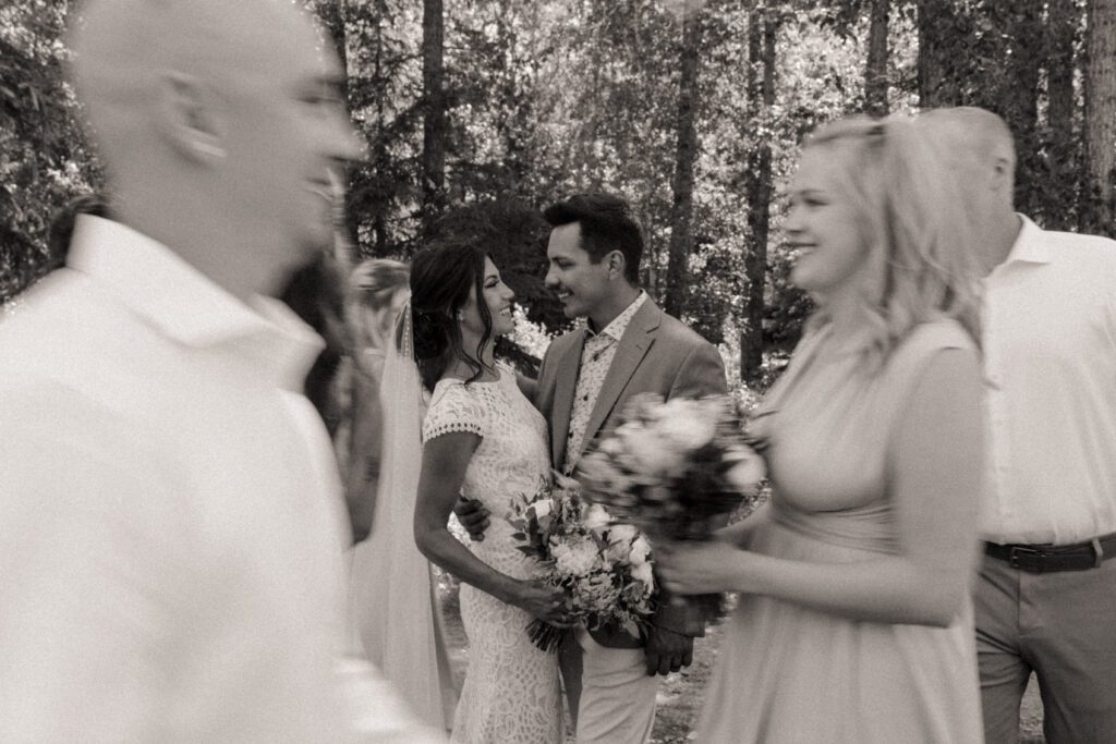 Bride and groom taking photos with their wedding party before their ceremony