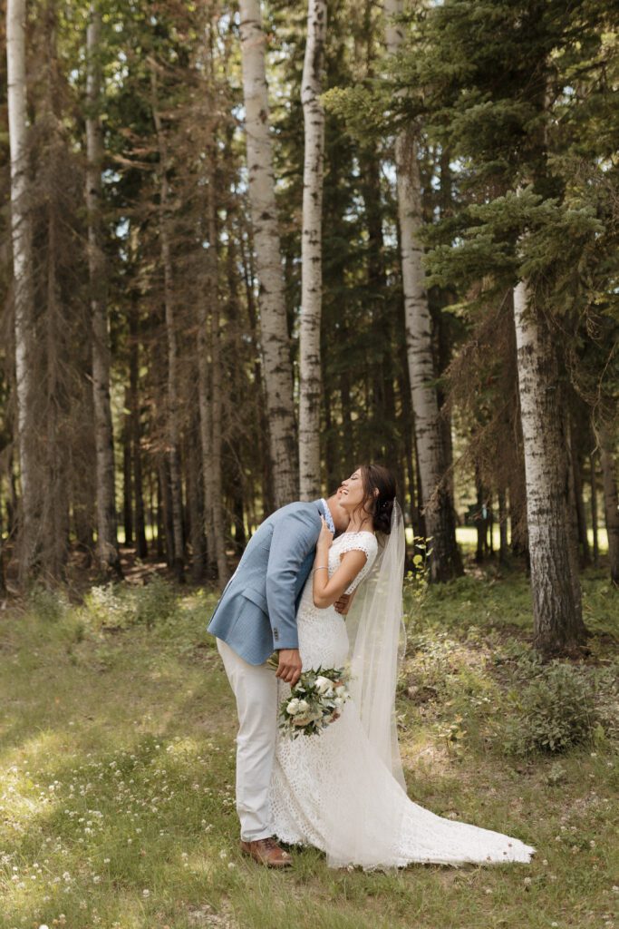 Bride and groom taking bridals in the forrest in Candle Lake Saskatchewan