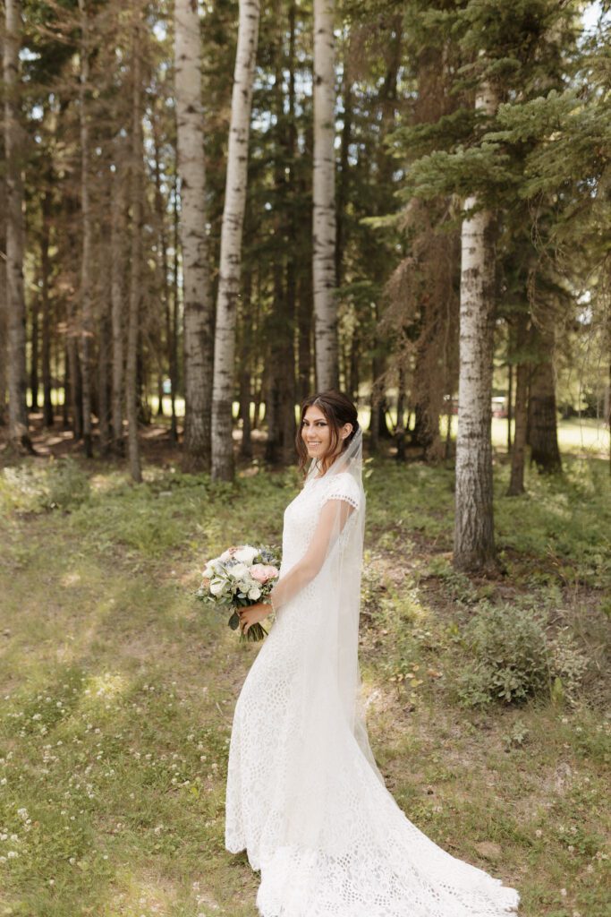 Bride taking bridals in the forrest before their lakeside wedding ceremony