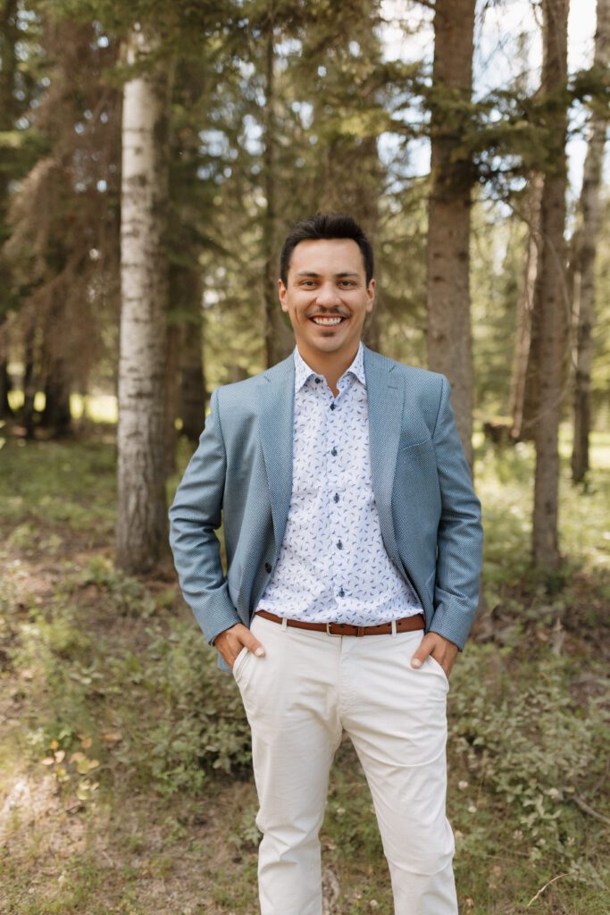 Groom during his formal portraits before their lakeside ceremony