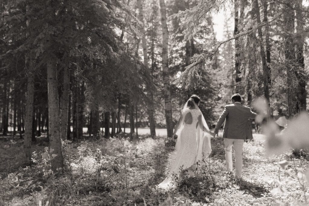 Bride and groom taking bridals in the forrest during their romantic woodland wedding day