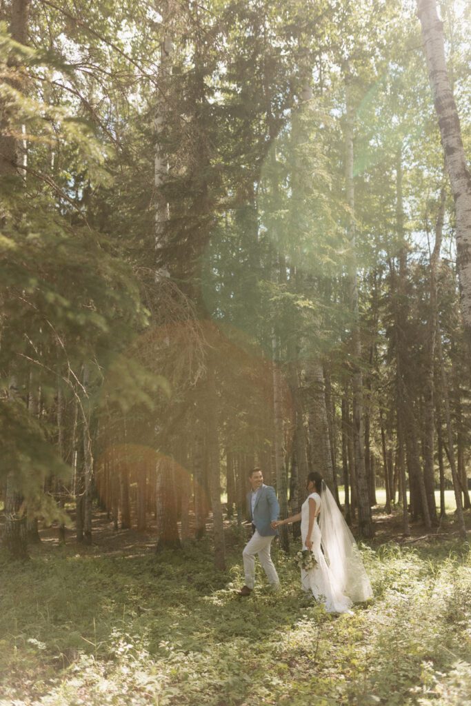 Bride and groom taking bridals in the forrest in Candle Lake Saskatchewan