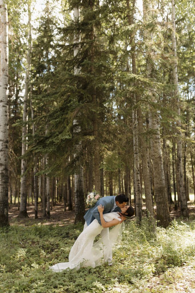 Bride and groom taking bridals in the forrest during their romantic woodland wedding day