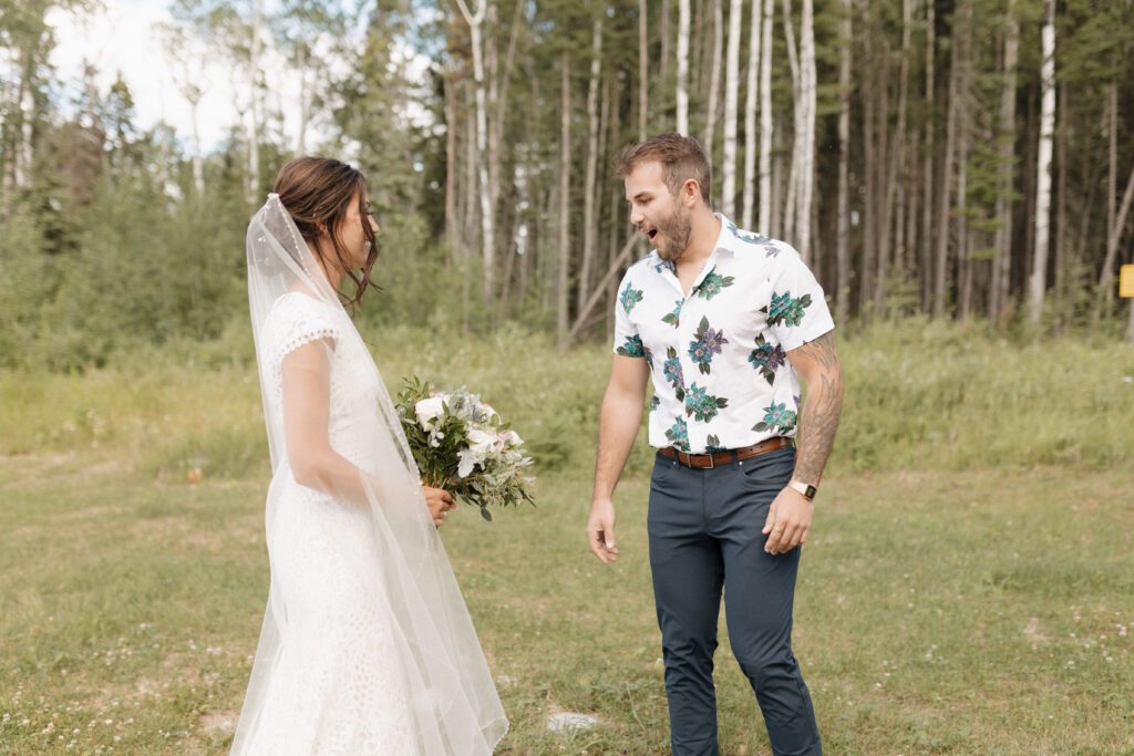 Bride and her brother during their first look before their Candle Lake Wedding