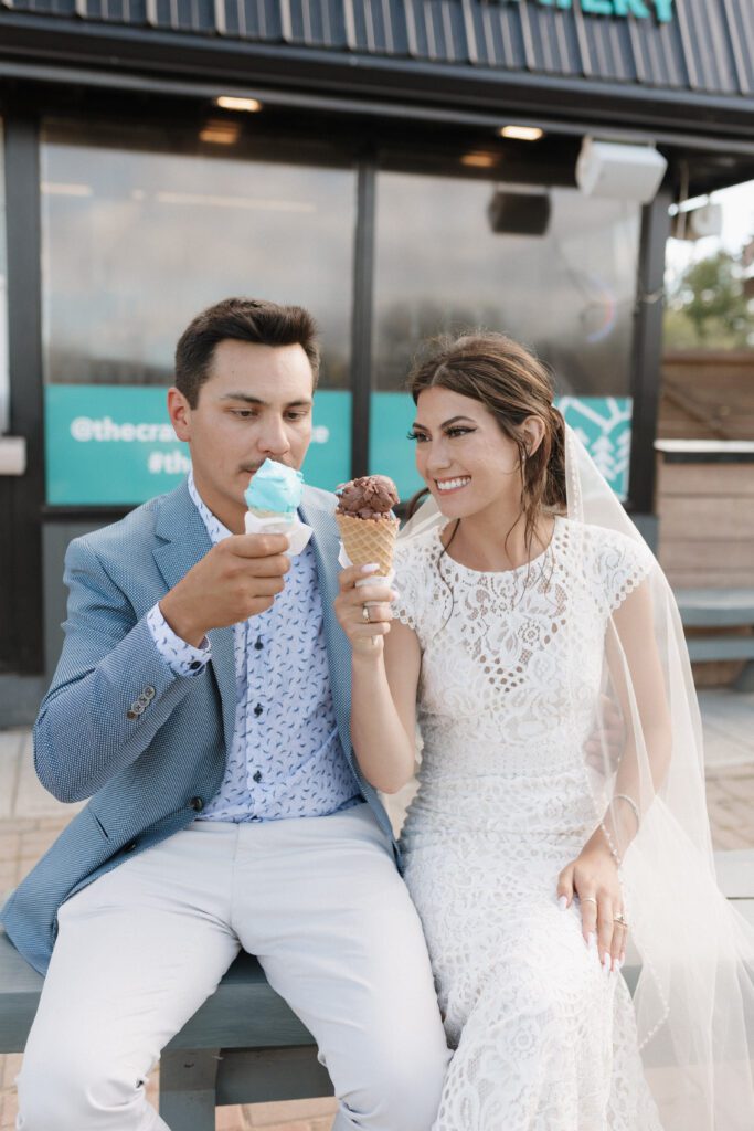 bride and groom celebrating their wedding with ice cream after their lakeside wedding ceremony