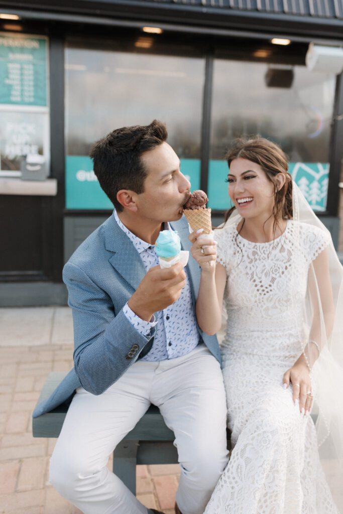 bride and groom celebrating their wedding with ice cream after their lakeside wedding ceremony