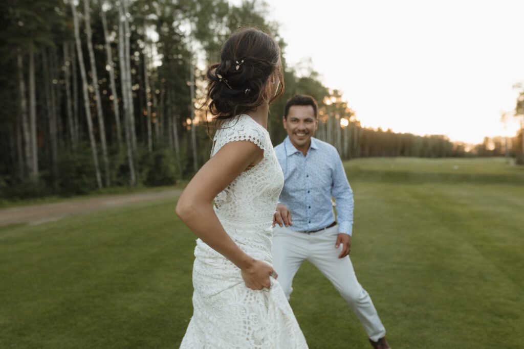 Bride and groom taking golden hour photos on the Candle Lake Golf course 