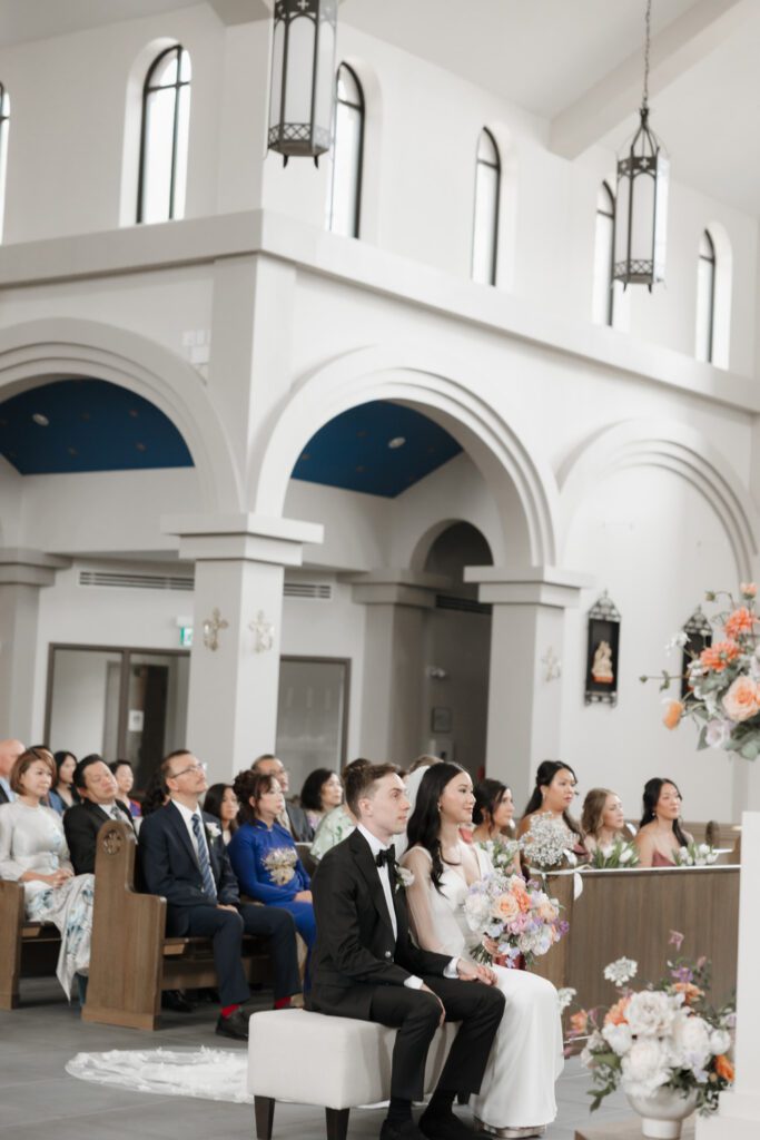 bride and groom listening in church