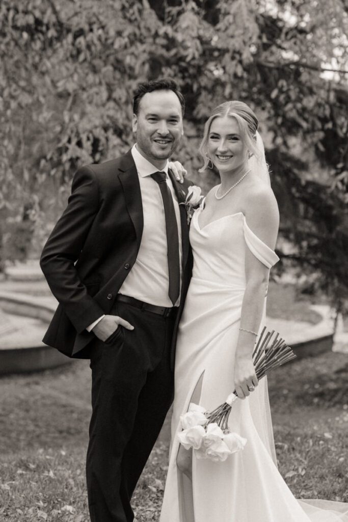 Black and white portrait of bride and groom forehead to forehead, capturing an intimate moment during their timeless Saskatoon wedding